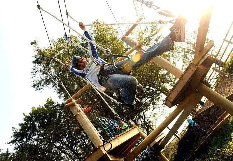 young boy on high ropes