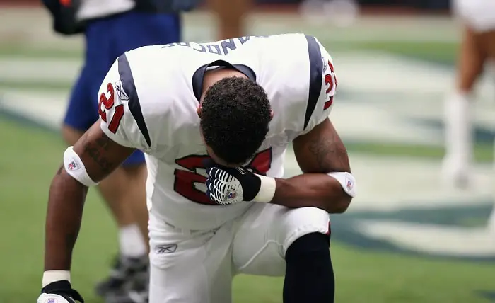 football player on bended knees