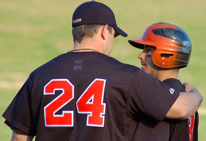 baseball coach and young player